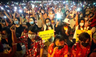 Protestors in Yangon shine their phone lights during a demonstration against Myanmar's military coup. Image credit: Theint Mon Soe/SOPA Images/LightRocket via Getty Images