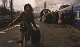 woman walking towards camera at train station