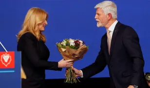 Slovakia's President Zuzana Caputova congratulates Czech presidential candidate Petr Pavel, at his headquarters, after the results of the country's presidential election are announced, in Prague, Czech Republic