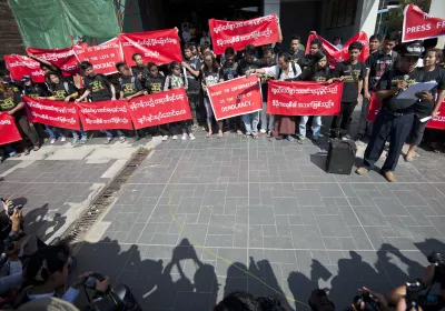 Reporters hold banners as they attend a demonstration march for press freedom. Yangon, Myanmar. 7 January 2014.  Editorial credit: Ye Aung Thu/AFP via Getty Images 