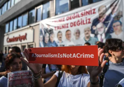  A journalist holds a banner on July 24, 2017 outside the headquarters of opposition daily newspaper Cumhuriyet in Istanbul. Editorial Credit:OZAN KOSE/AFP via Getty Images.