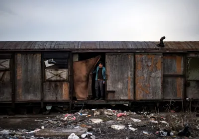 A migrant stands inside an abandoned train wagon used as a makeshift shelter near the main rail station in Belgrade, Serbia. Andrej Isakovic, AFP/Getty Images