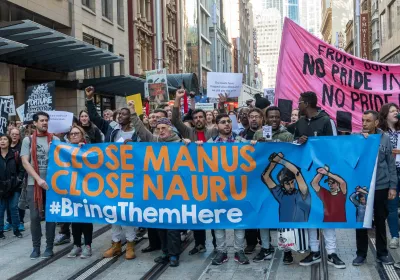 Hundreds of protesters march through Sydney, Australia calling for the Australian government to close the refugee camps on Manus and Nauru islands. Editorial credit: Holli / Shutterstock.com