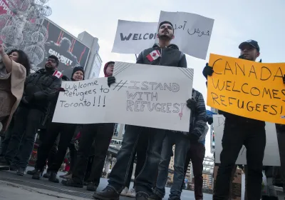Protest with signs "Canada Welcomes Refugees"
