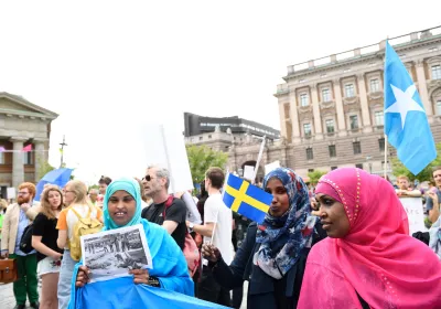 Protesters gather in front of Sweden's parliament in Stockholm on June 21, 2016 to protest the newly approved legislation to tighten regulations for asylum and family reunification in the Scandinavian country which had a record 160,000 asylum-seekers last year.