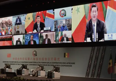 Dakar, Senegal – Nov. 29, 2021 – Chinese President Xi Jinping (on the screen) delivers a speech during the China-Africa Cooperation (FOCAC) meeting in Dakar. Photo by Seyllou/AFP via Getty Images.
