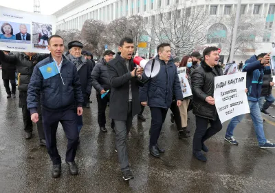 People hold a rally in memory of victims of the recent country-wide unrest triggered by fuel price increase in Almaty, Kazakhstan, February 13, 2022