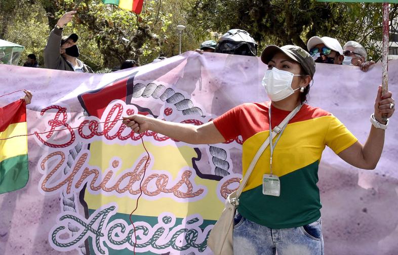 A protester wears a face mask at a political demonstration in Bolivia during the coronavirus pandemic. Credit: Aizar Raldes/AFP via Getty Images. 